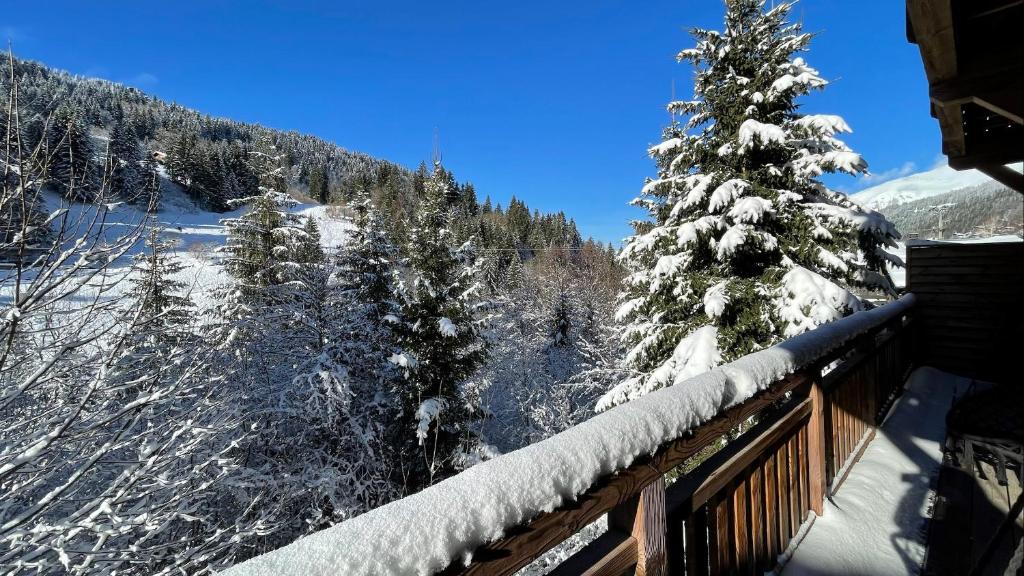 a view of a snow covered mountain from a balcony at Chalet La Mésange Boréale in Morzine