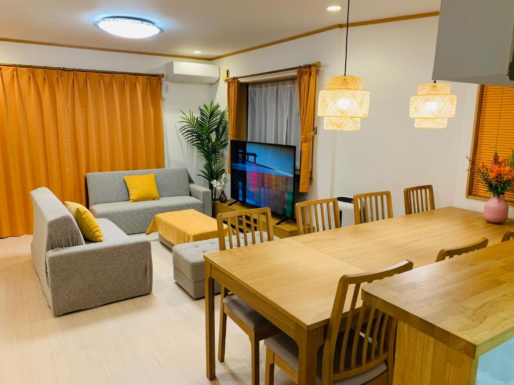 a living room with a table and a dining room at Kamei House in Tokyo
