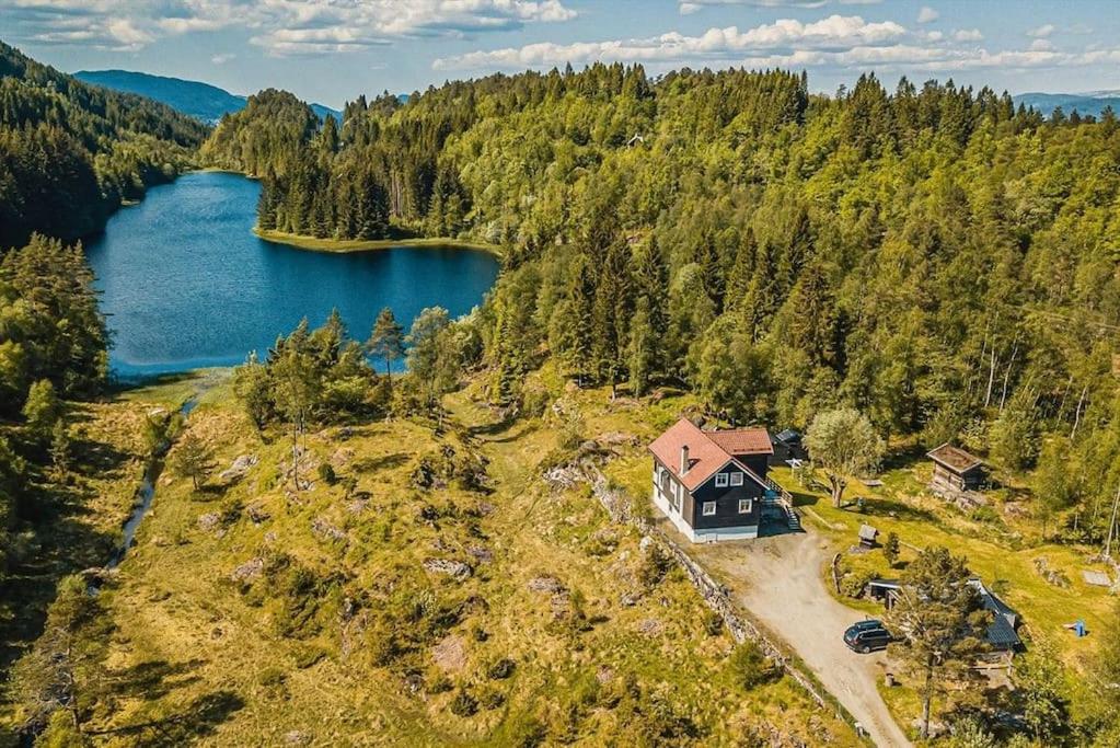 an aerial view of a house next to a lake at Beautiful Private Villa with Lake View and Boat in Hålland