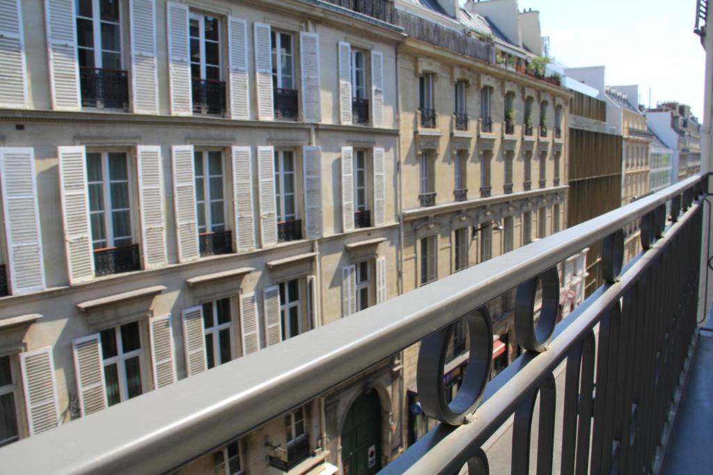a row of buildings with windows on a balcony at FINESTATE Coliving Champs-Elysées in Paris