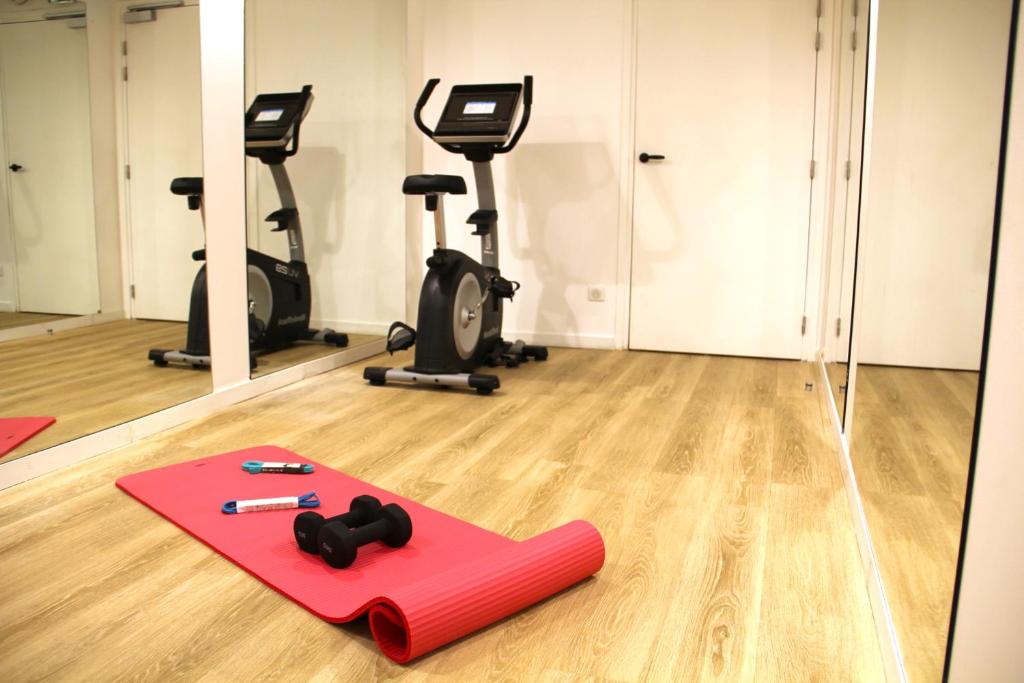 a fitness room with exercise mats and exercise bikes at FINESTATE Coliving Champs-Elysées in Paris