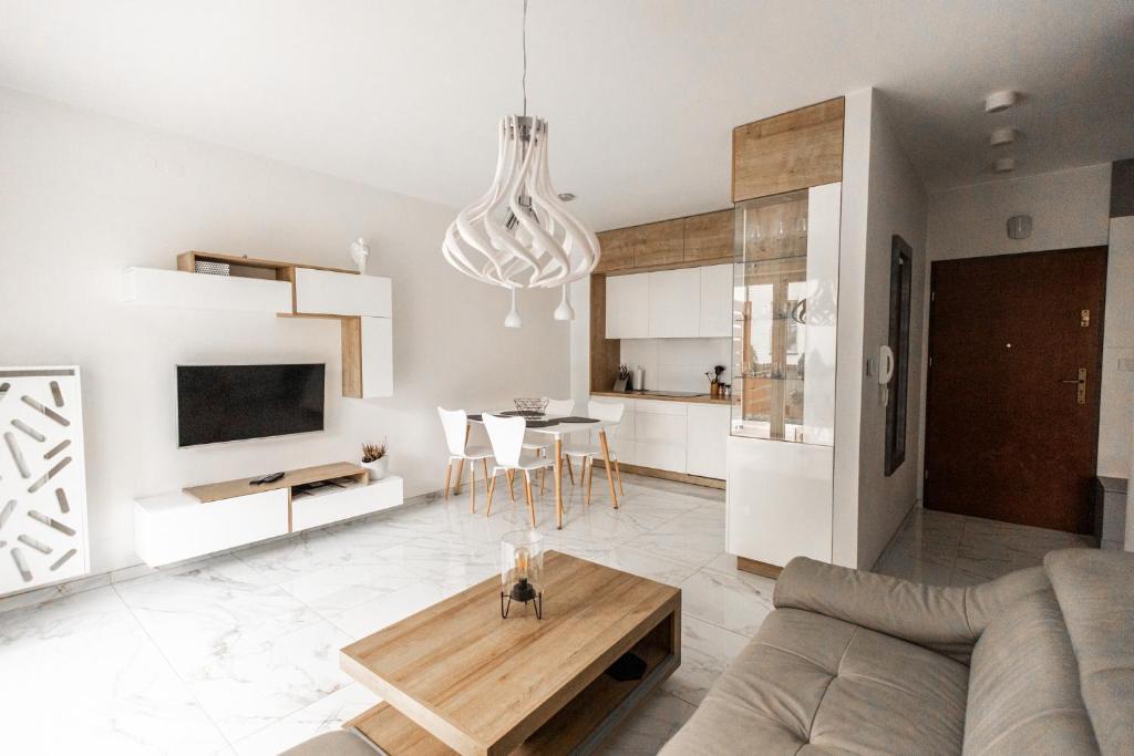 a living room with a couch and a table at Apartament przy bulwarach w Straconce in Bielsko-Biala