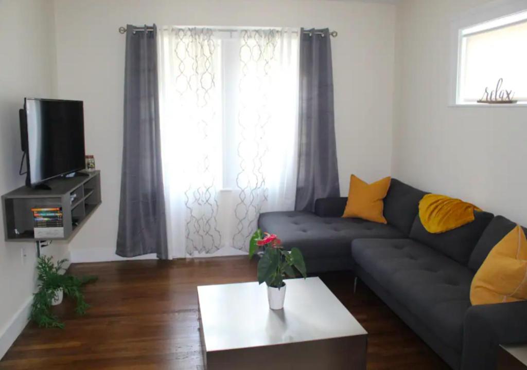 a living room with a couch and a tv at Designer Three Bd Apartment In NYC in New York