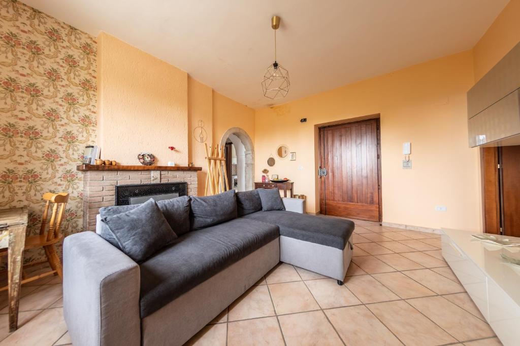 a living room with a couch and a fireplace at #914 Home - Irpinia in Nusco