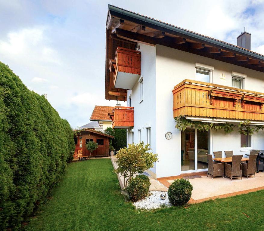 a house with a patio and a yard at CATO Ferienhaus in Kiefersfelden