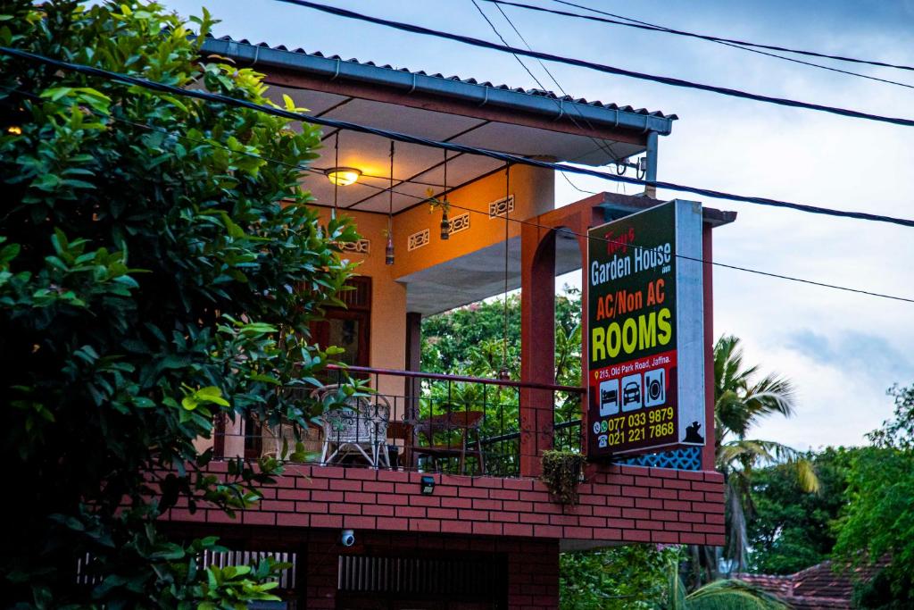a building with a sign in front of it at Tony's Garden House Back Packers inn in Jaffna