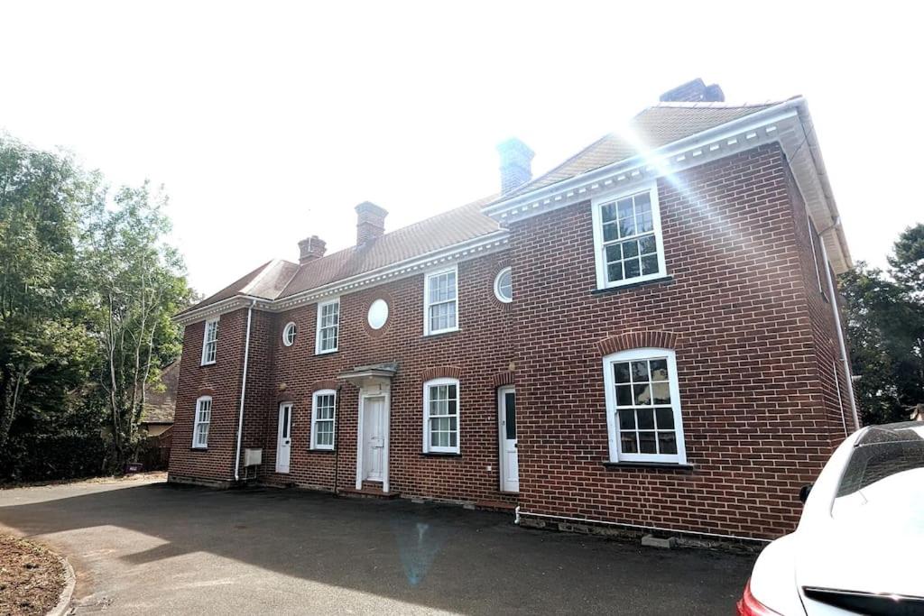 a red brick house with a car parked in front of it at Spacious & Budget Friendly 5 Bed Home! in Maidenhead