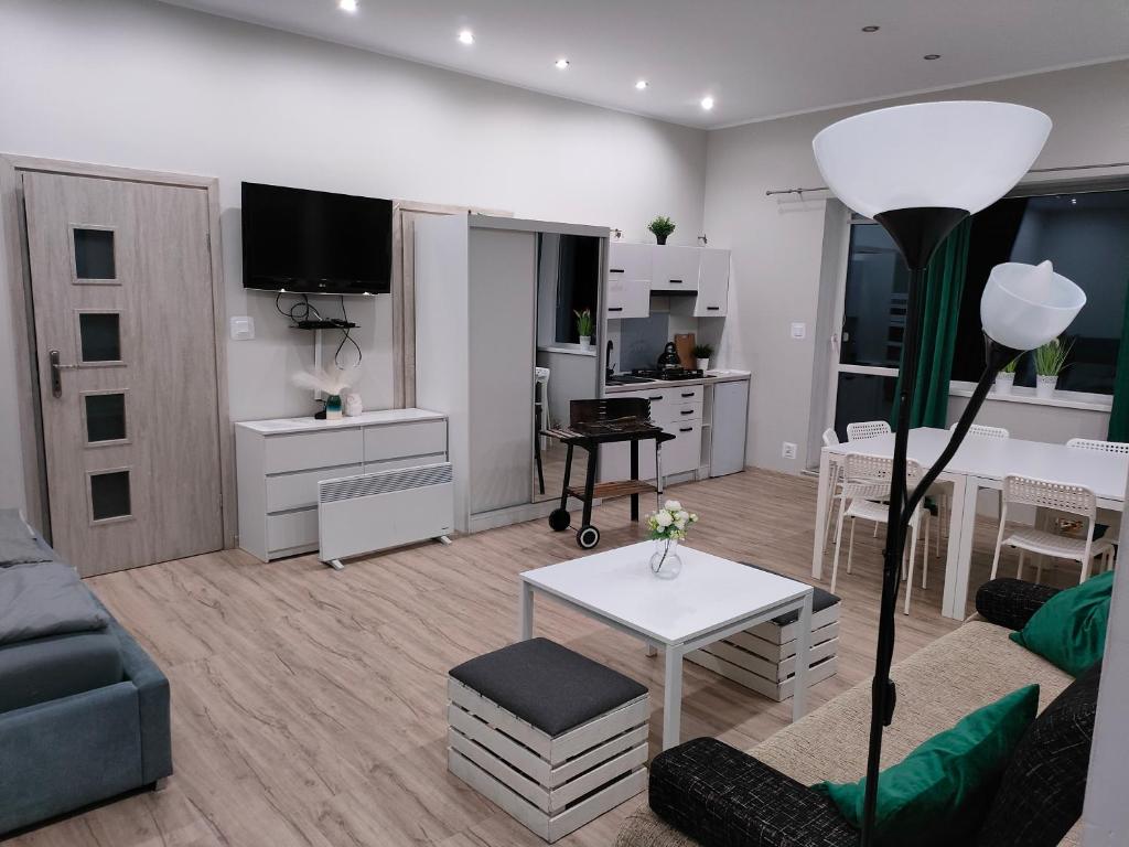 a living room with a couch and a table at Apartament Baranek Nad Jeziorem in Gostycyn