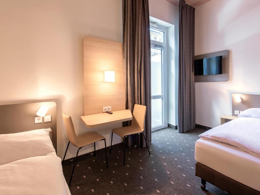 Postel nebo postele na pokoji v ubytování B&B Hotel Nürnberg-Hbf