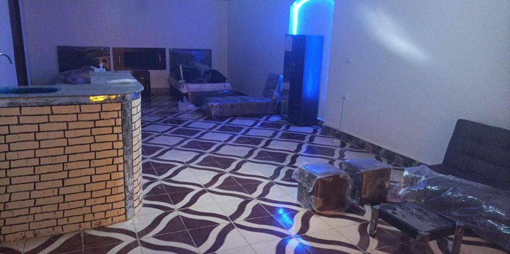 a living room with a tile floor and a blue light at akhnaten villa in Cairo