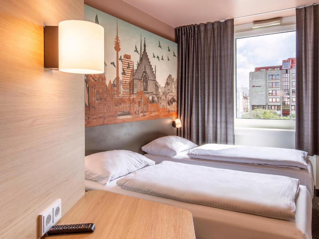 Postel nebo postele na pokoji v ubytování B&B Hotel Nürnberg-Hbf