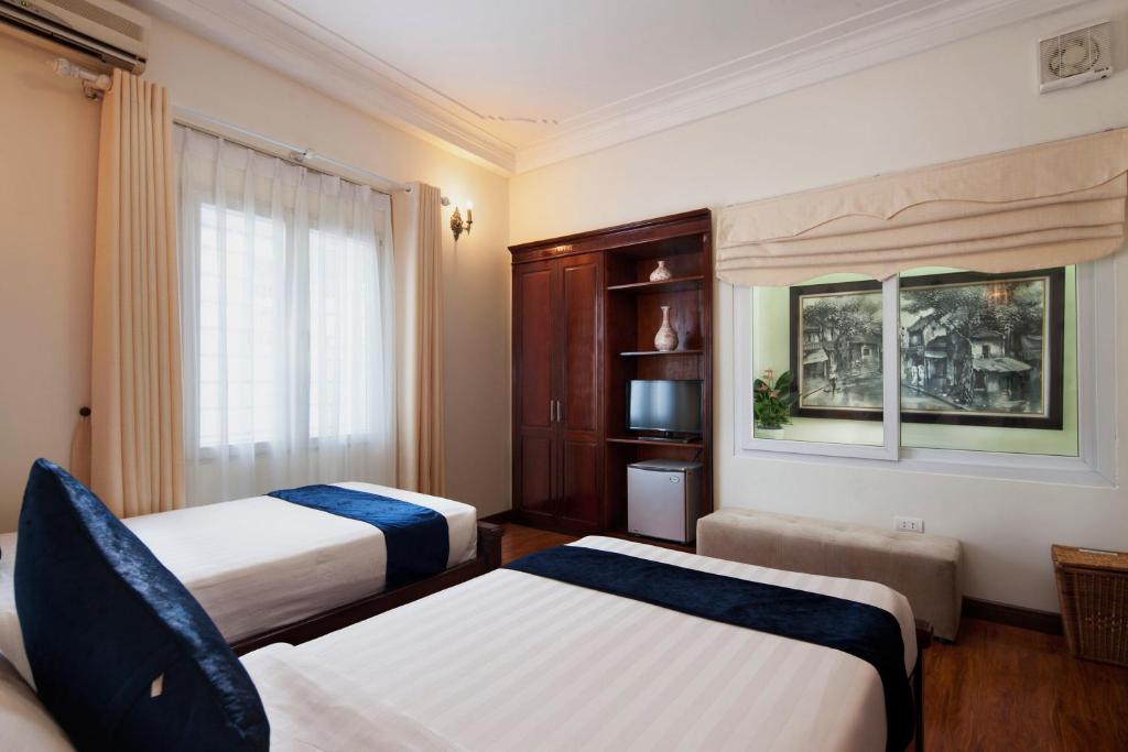 Postel nebo postele na pokoji v ubytování Hanoi Golden Moon Hotel & Travel