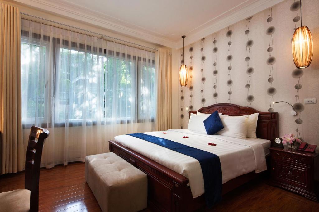 a bedroom with a large bed and a window at Hanoi Golden Moon Hotel in Hanoi