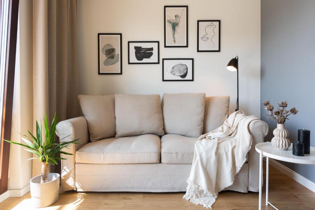 a living room with a couch and a table at Flatbook - City Center SPA Apartments Toruńska 11 in Gdańsk