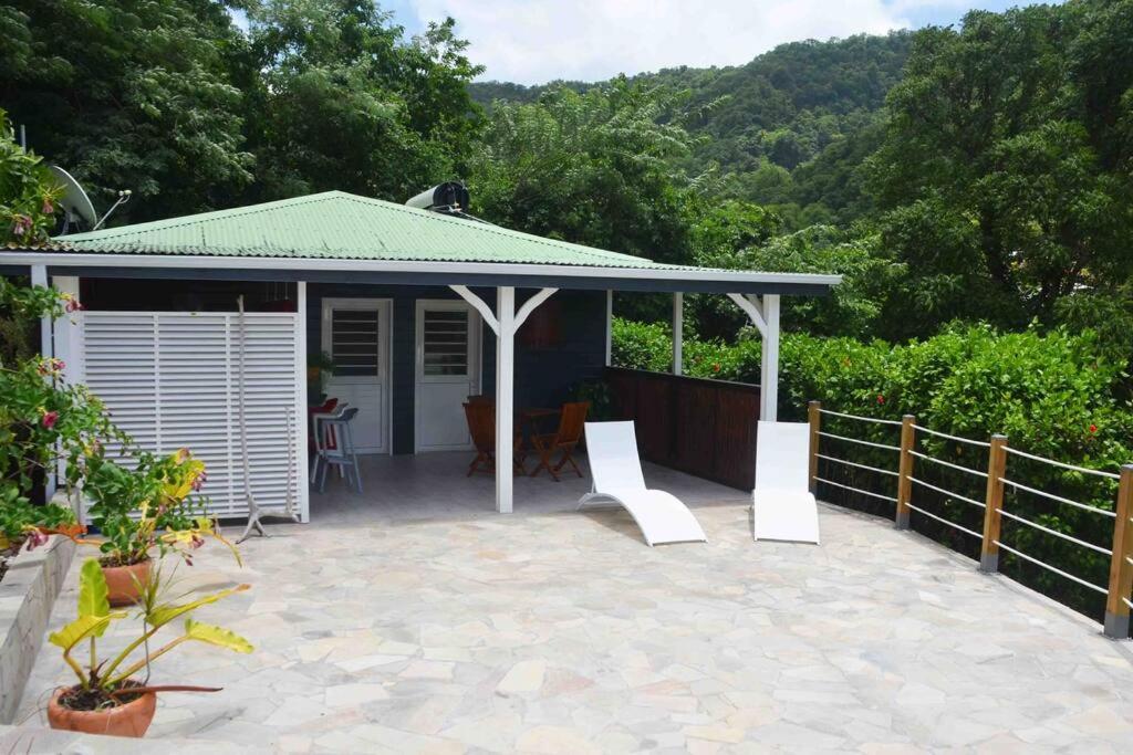 a pavilion with a table and chairs on a patio at kaï colibri in Rivière-Pilote