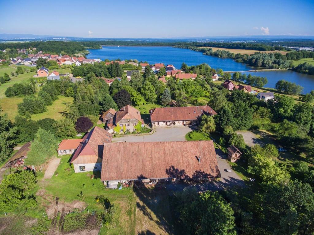 an aerial view of a large house with a river at Hôtel du DOMAINE SAINT LOUP 