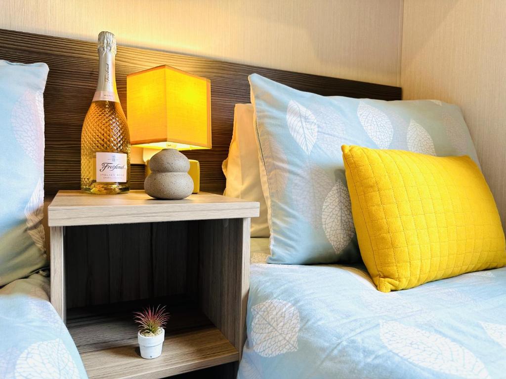 um quarto com uma cama e uma mesa de cabeceira com um candeeiro em Adelfas em Scarborough