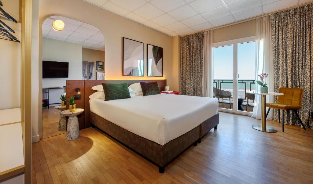 a hotel room with a bed and a balcony at Charlie in Pesaro in Pesaro