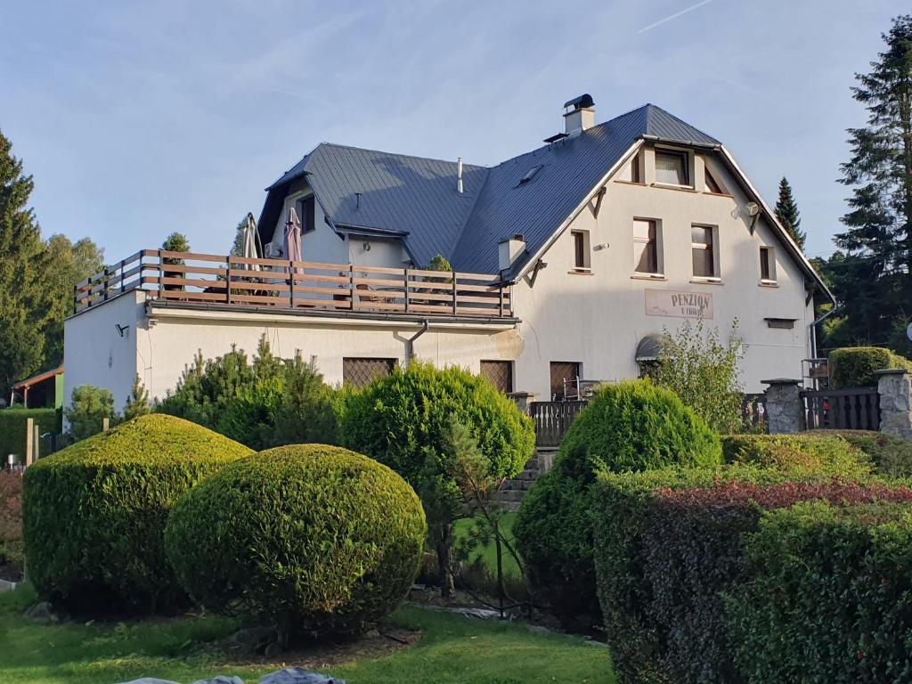 a large white house with a black roof at Penzion U Elišky in Liberec