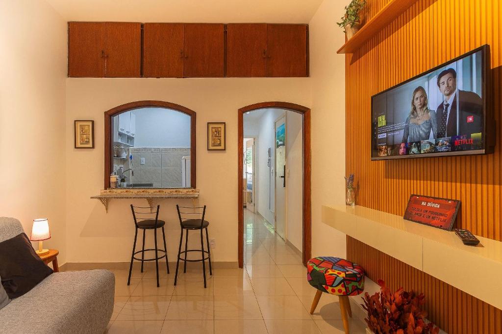 a living room with a flat screen tv on a wall at Copacabana Beachside Retreat in Rio de Janeiro
