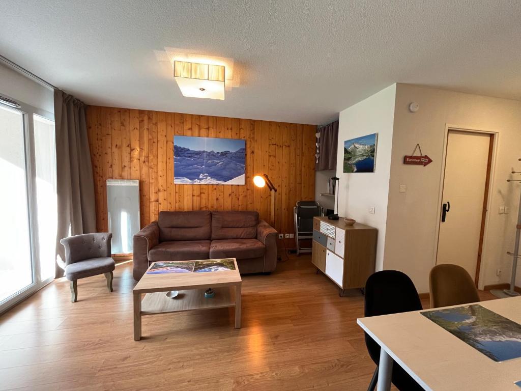 a living room with a couch and a table at Appartement V de ROLAND Luz VDR212 in Luz-Saint-Sauveur