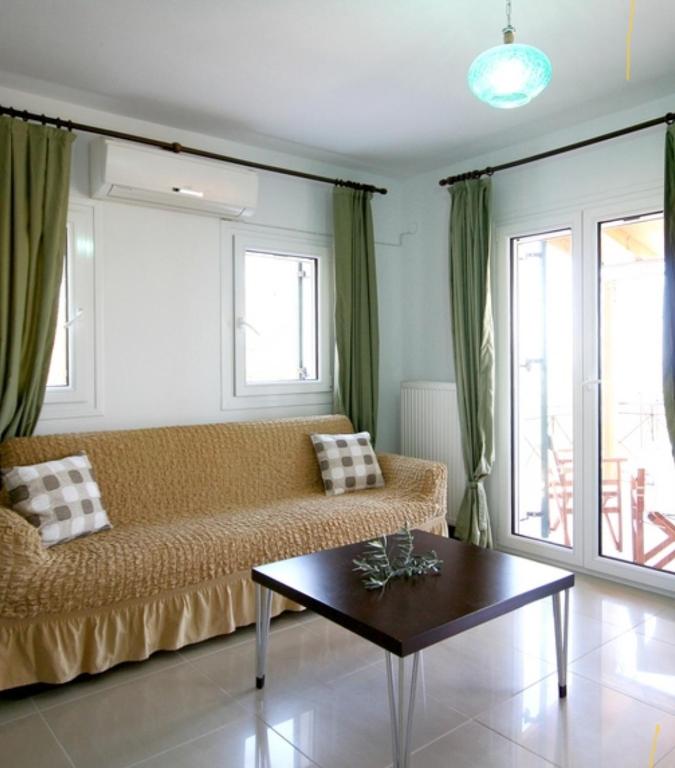 a living room with a couch and a table at Ktima Apostolou in Aspropótamos