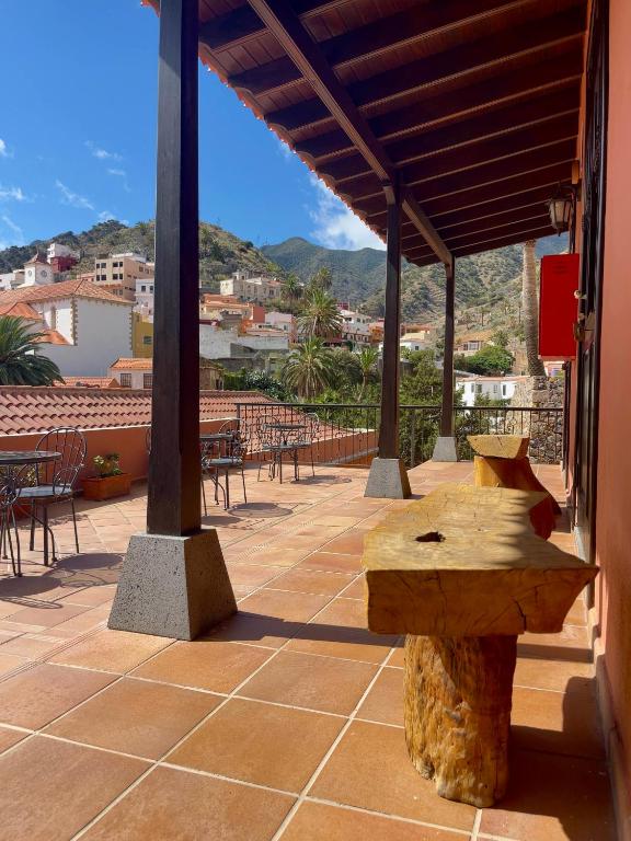 a wooden bench sitting on top of a patio at Tamahuche Hotel Rural in Vallehermoso