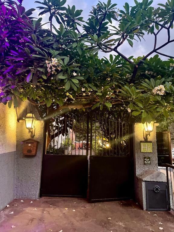 a black gate with flowers on top of it at Tamahuche Hotel Rural in Vallehermoso