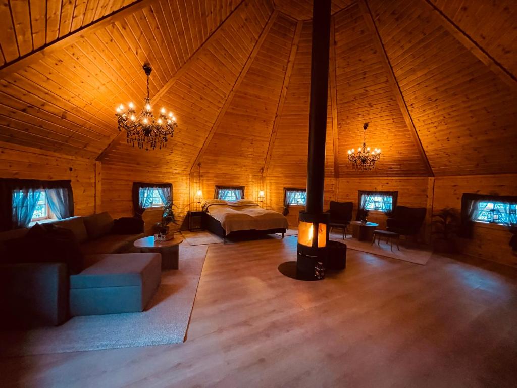 a large living room in a wooden cabin with a couch at Koselig dyregård i Tromsø in Tromsø