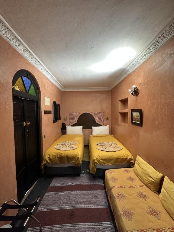 a room with two beds and a couch at Dar Bargach in Tangier