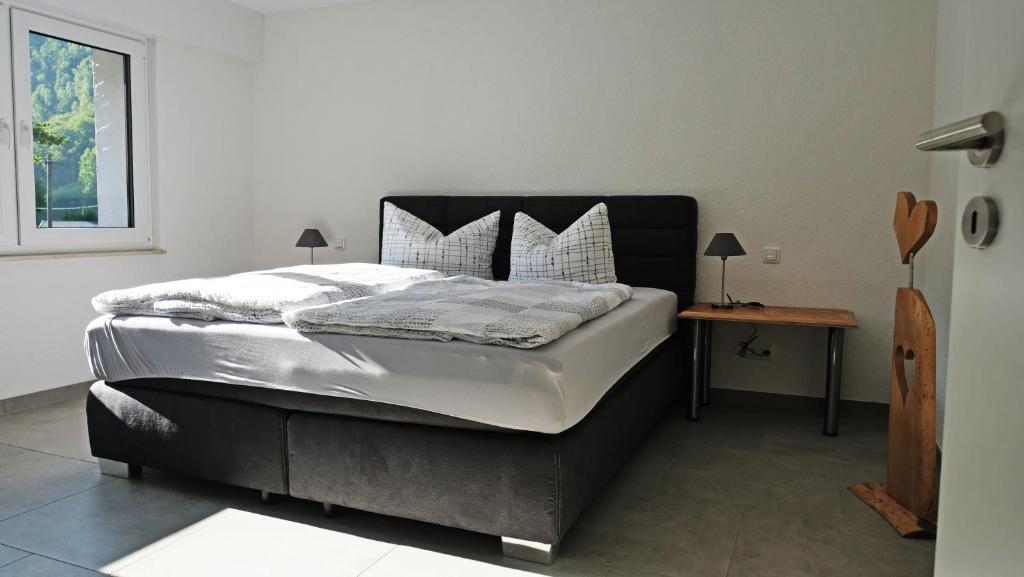 een groot bed in een kamer met een tafel bij Gut Kallerbend in Nideggen