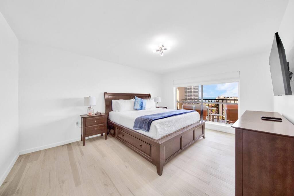 a bedroom with a bed and a balcony at Amazing 7th floor beachfront condo wonderful views in South Padre Island