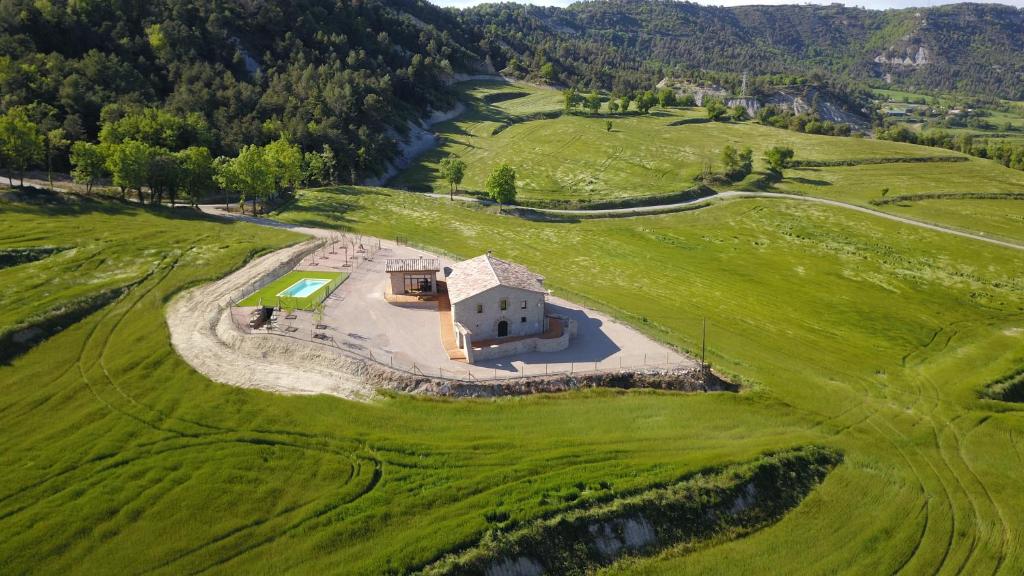 an aerial view of a house in a green field at Mas el Coll in El Gurb