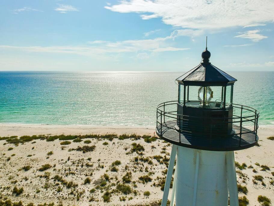 a lighthouse on the beach next to the ocean at Everglade Kiss 3b 2b BBQ, hot tub in Port Charlotte