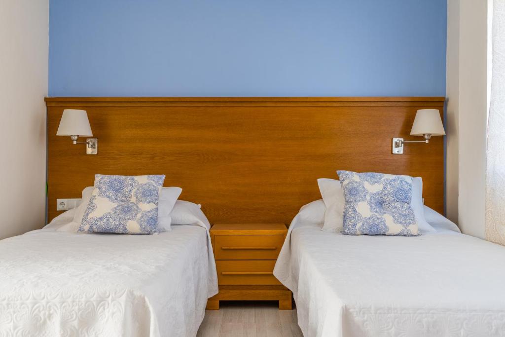 Postel nebo postele na pokoji v ubytování Hostal Imperial