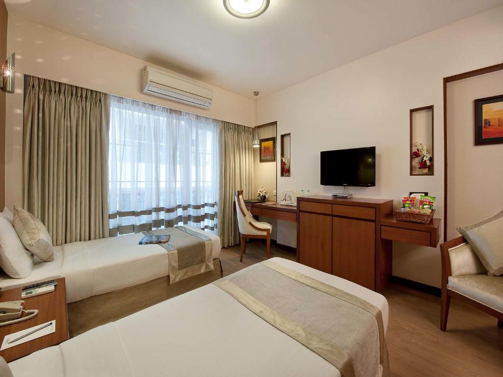 TV a/nebo společenská místnost v ubytování Grand Residency Hotel & Serviced Apartments