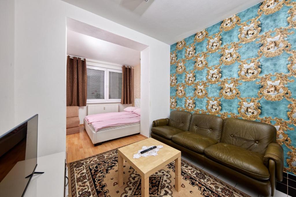 a living room with a couch and a table at Destiny apartment in Bratislava