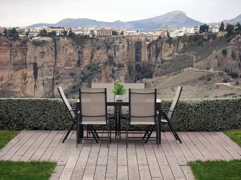 a table and chairs with a view of a mountain at La Marabulla in Ronda