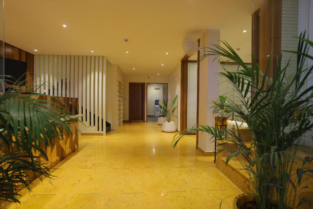 a hallway with potted plants in a building at The Grand Uddhav - A Boutique Hotel in Udaipur