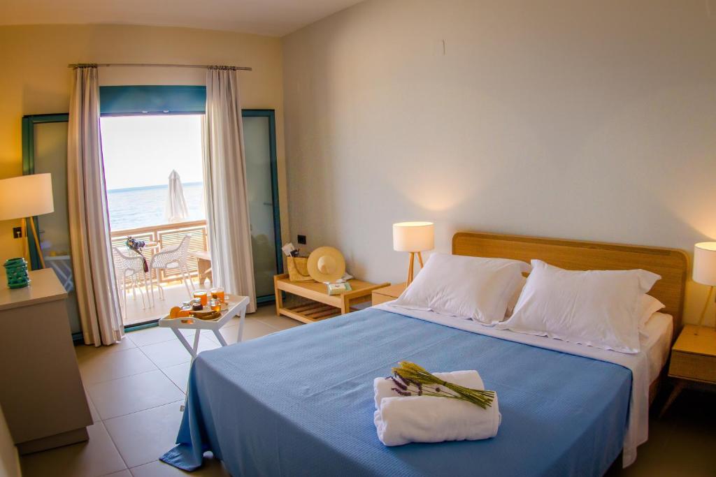 a bedroom with a bed with a view of the ocean at Alas in Argasi