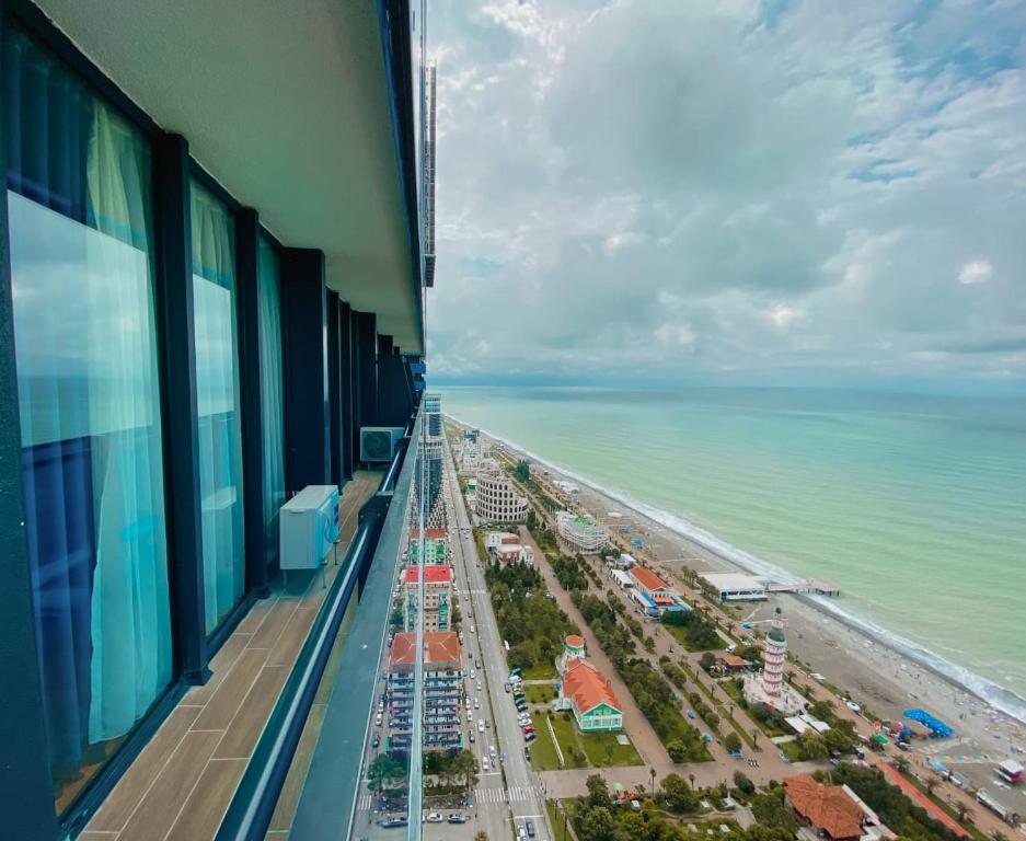 a view of the beach from the balcony of a building at Orbi floor40 in Batumi