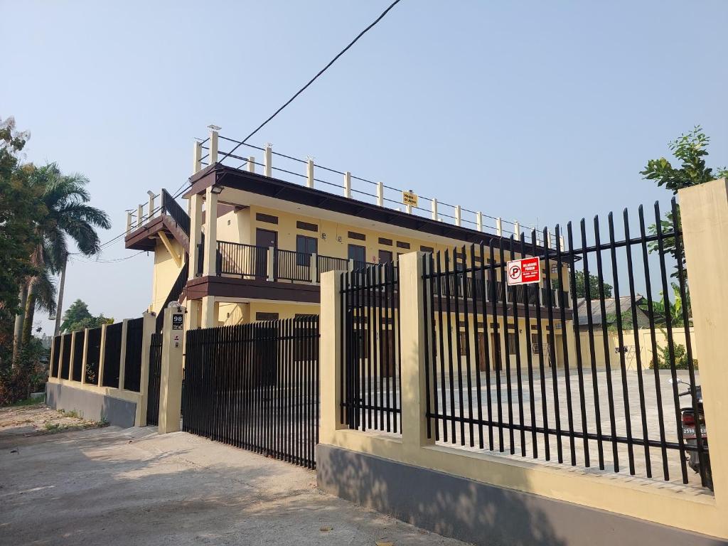 a fence in front of a house with a gate at RiReRa Guest House Bogor Syariah in Kemangjampang