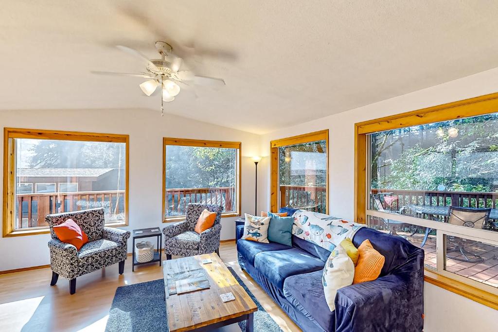 a living room with a couch and chairs and windows at Bait Shop in Carpenterville