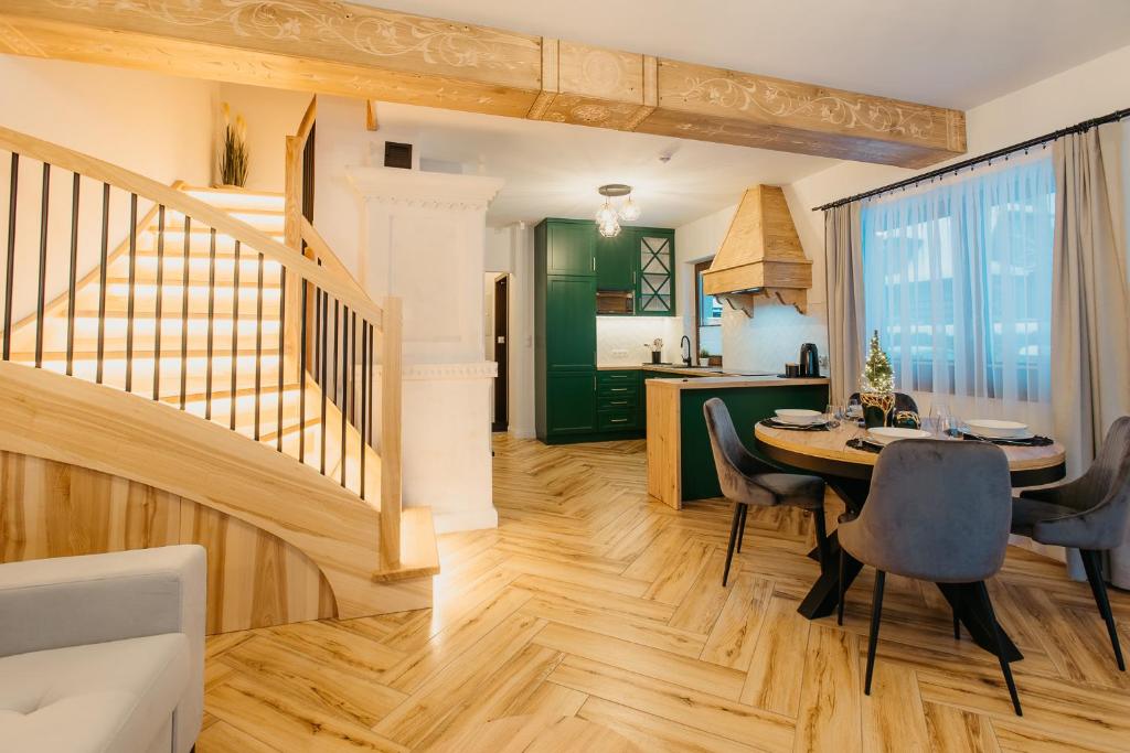 a kitchen and dining room with a table and chairs at Domek na Wilczniku in Zakopane