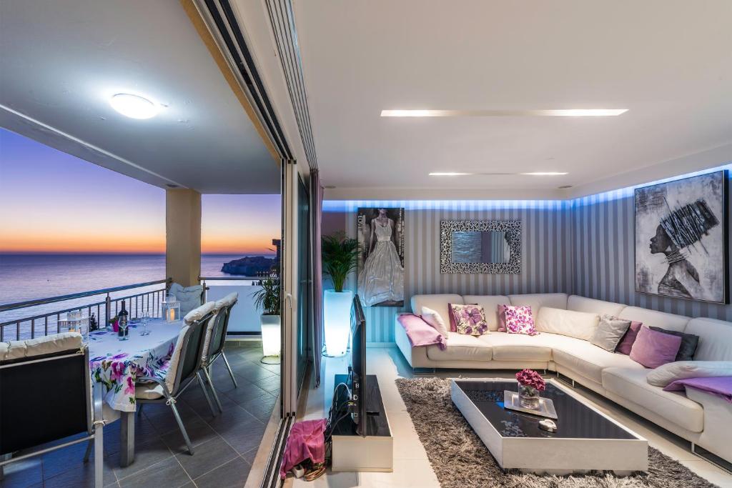 a living room with a couch and a view of the ocean at Apartments Lavander & Violet in Dubrovnik