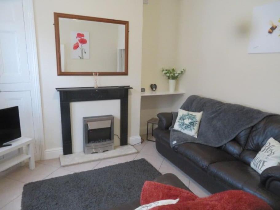 a living room with a couch and a fireplace at 29 Lewes Road - Darlington in Darlington