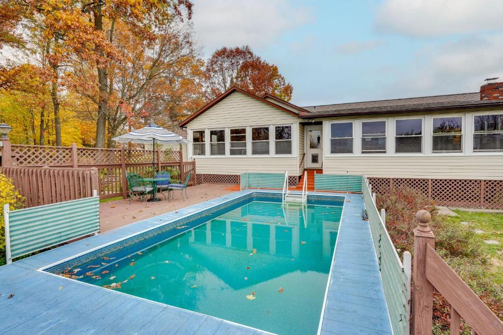 a swimming pool in front of a house at Pet-Friendly Ohio Escape with Pool, Deck and Fire Pit! in Mount Vernon