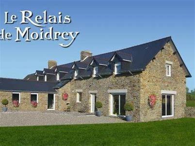 a large brick house with a black roof at Relais de Moidrey in Moidrey