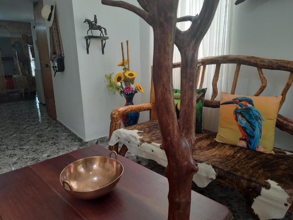 a room with a table with a bowl on top of it at Apartamento Campestre Medellin in Medellín