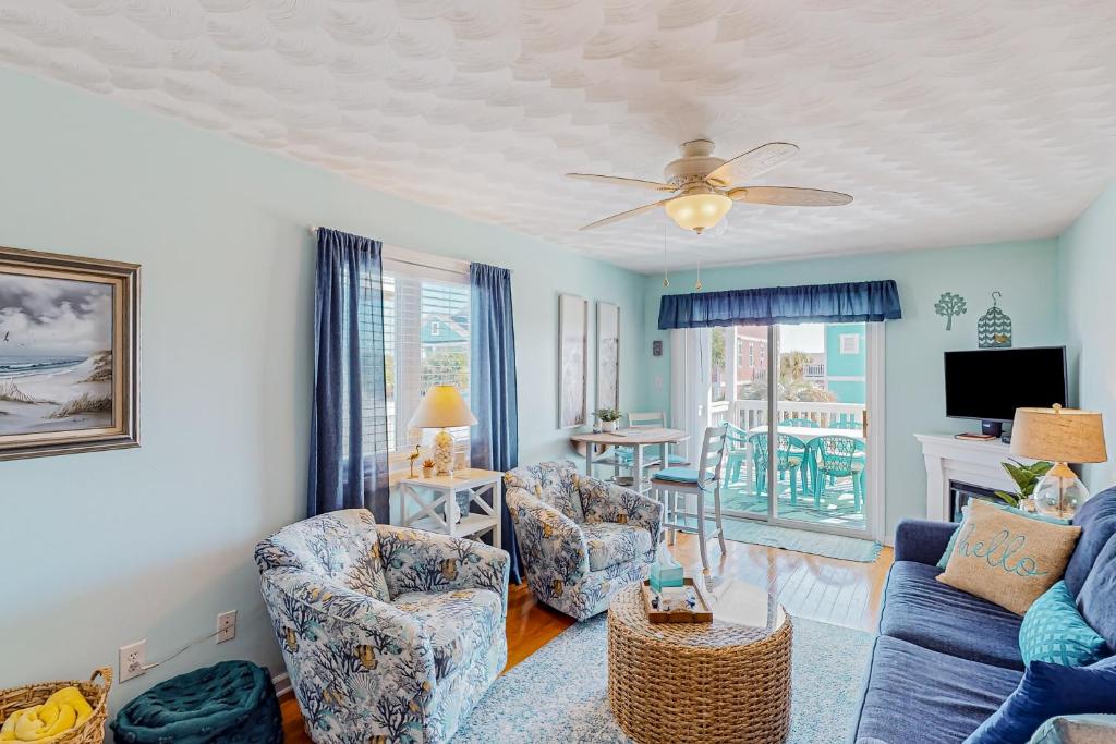 a living room with a couch and chairs and a tv at Captain's Villa 9-C Sunshine Ally in Holden Beach